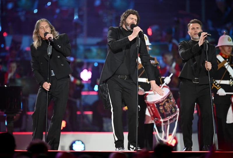 Mark Owen, Howard Donald and Gary Barlow from Take That on stage at the Coronation Concert (PA)