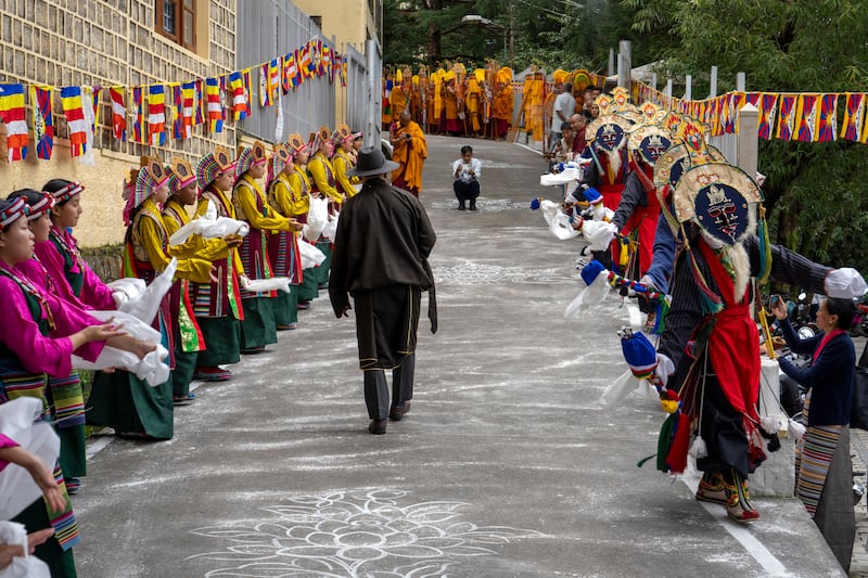 Exiled Tibetans in costumes took part ina traditional dance to welcome their spiritual leader (AP)