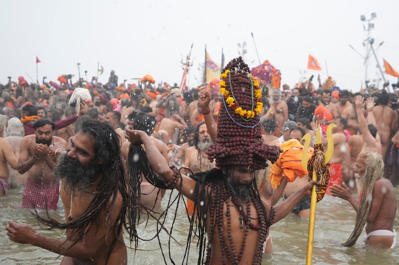 Naga Sadhus, or naked Hindu holy men, take dips on one of the most auspicious days of the Maha Kumbh festival (Rajesh Kumar Singh/AP)