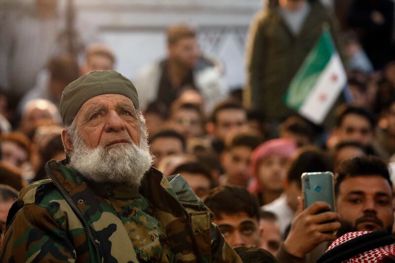 An old man looks on as Syrians attend Friday prayers inside the 7th century Umayyad Mosque (Omar Sanadiki/AP)