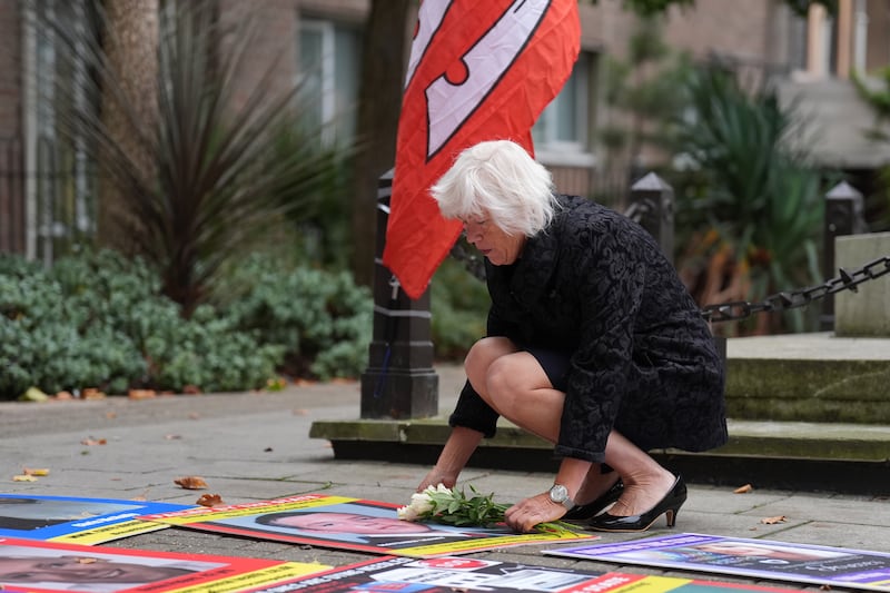 Melanie Leahy, whose son Matthew died in 2012 while a patient at the Linden Centre in Chelmsford, lays flowers on a photo of him outside the Lampard Inquiry