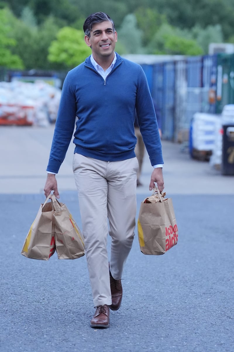 Rishi Sunak often pairs his blue knit with traditional taupe chinos and brown brogues