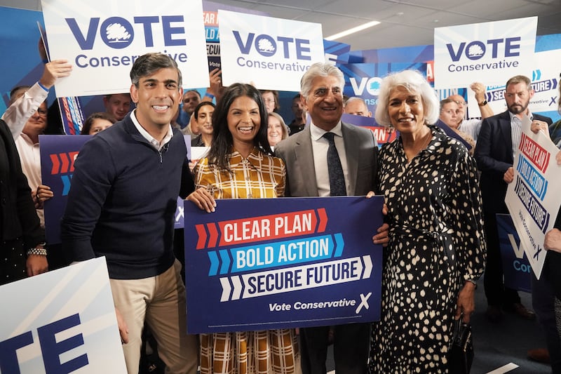 From left, Prime Minister Rishi Sunak, his wife Akshata Murty and his parents Usha and Yashvir Sunak at Romsey Rugby Club, Hampshire during the campaign