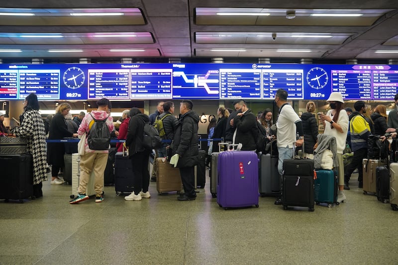 Passengers queue at St Pancras International station in London as Christmas getaway disruption is expected to continue