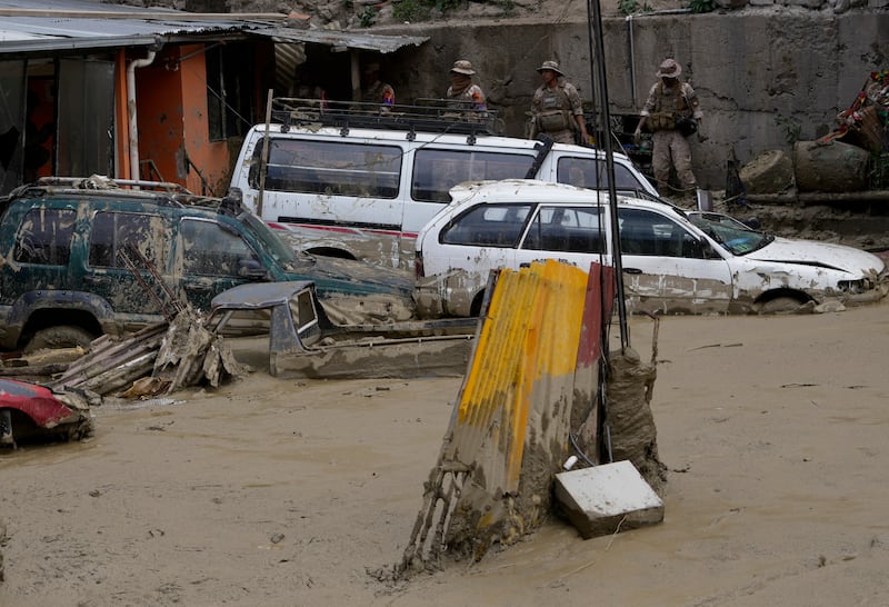 Cars are partially buried in mud in an area affected by a landslide triggered by heavy rains in La Paz (Juan Karita/AP)