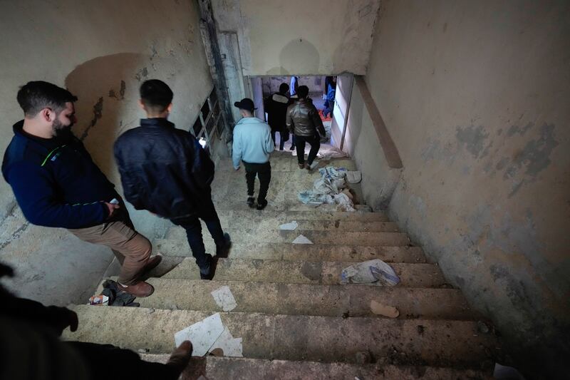 People walk into the basement of the infamous Saydnaya military prison (Hussein Malla/AP)