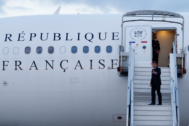 Emmanuel Macron boards a plane to travel to the Pacific archipelago of New Caledonia (Ludovic Marin/Pool Photo via AP)