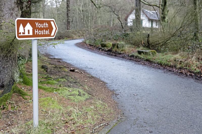Youth hostel and sign post direction for walkers, travellers and tourists in rural countryside wilderness 