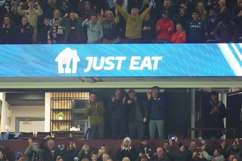 The Prince of Wales (centre left) celebrates in the stands after Aston Villa score