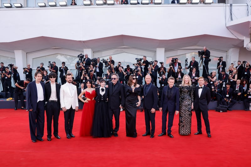 Jeremy Kleiner, Arthur Conti, Justin Theroux, Jenna Ortega, Winona Ryder, Tim Burton, Monica Bellucci, Michael Keaton, Willem Dafoe, Catherine O’Hara and producer Tommy Harper pose for photographers (Vianney Le Caer/Invision/AP)