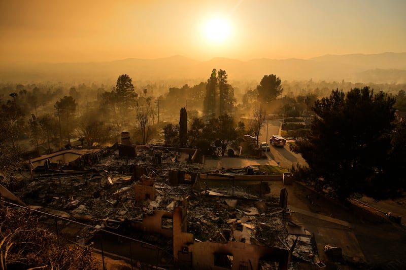 An emergency vehicle drives through a neighbourhood devastated by the Eaton Fire in Altadena, California (John Locher/AP)