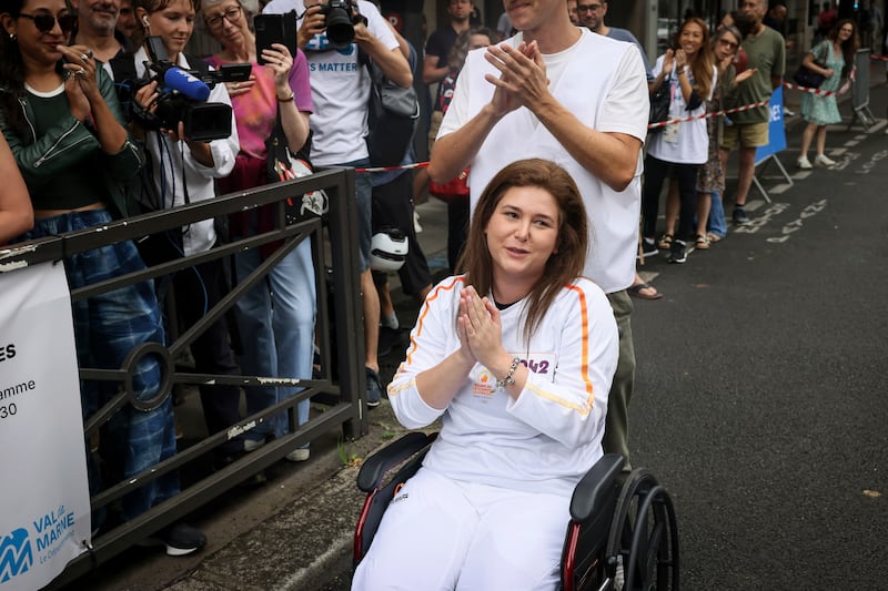 Press agency photographer Christina Assi arrives for the Olympic torch relay in Vincennes, outside Paris (Thomas Padilla/AP)