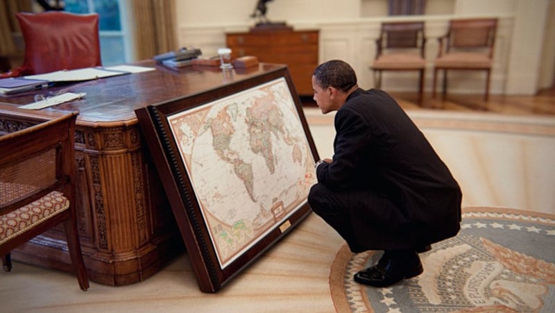 Barack Obama considers the world in the Oval Office