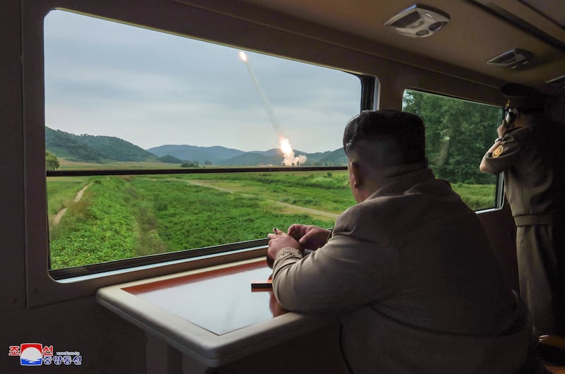 In this undated photo provided on Friday by the North Korean government, Kim Jong Un inspects what they say is test firing from a new launch vehicle (Korean Central News Agency/Korea News Service via AP)