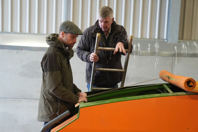 Farmer Phil Gorringe shows the Prince of Wales a seed drill machine