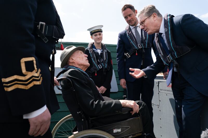 Labour Party leader Sir Keir Starmer on a Second World War landing craft speaking to veteran Lieutenant Commander Len Chivers, 99, during a visit to Portsmouth