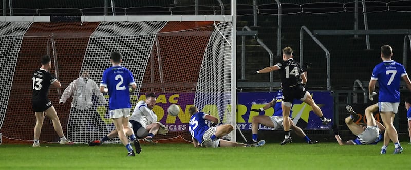 Jerome Johnston of Kilcoo scoring his side's first goal against Rory Beggan of Scotstown in the Ulster Club Senior championship semi-final at BOX-IT Athletic Grounds Armagh.  Picture: Oliver McVeigh