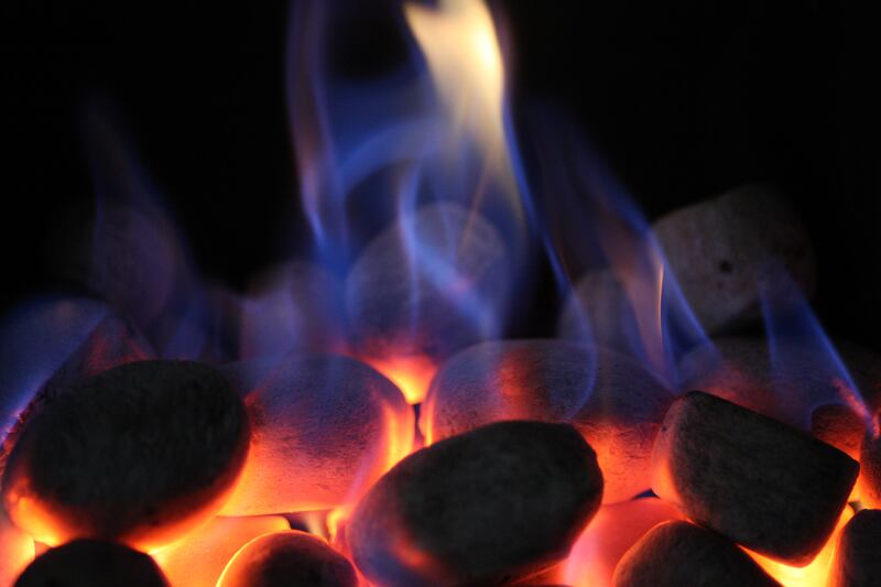 Ornamental coals glow on an open gas fire