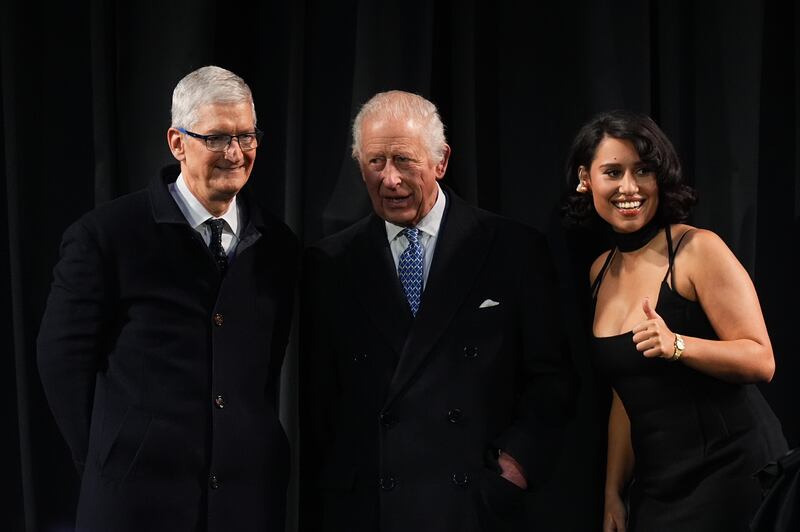 Charles, centre, with Apple chief executive Tim Cook, left, and singer Raye