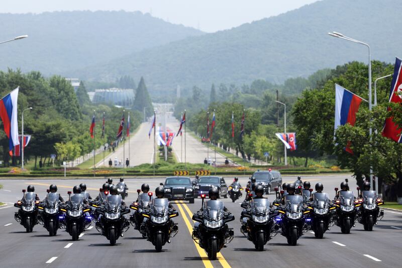 The motorcade of Russian President Vladimir Putin drives along a street in Pyongyang (Gavriil Grigorov, Sputnik, Kremlin Pool/AP)