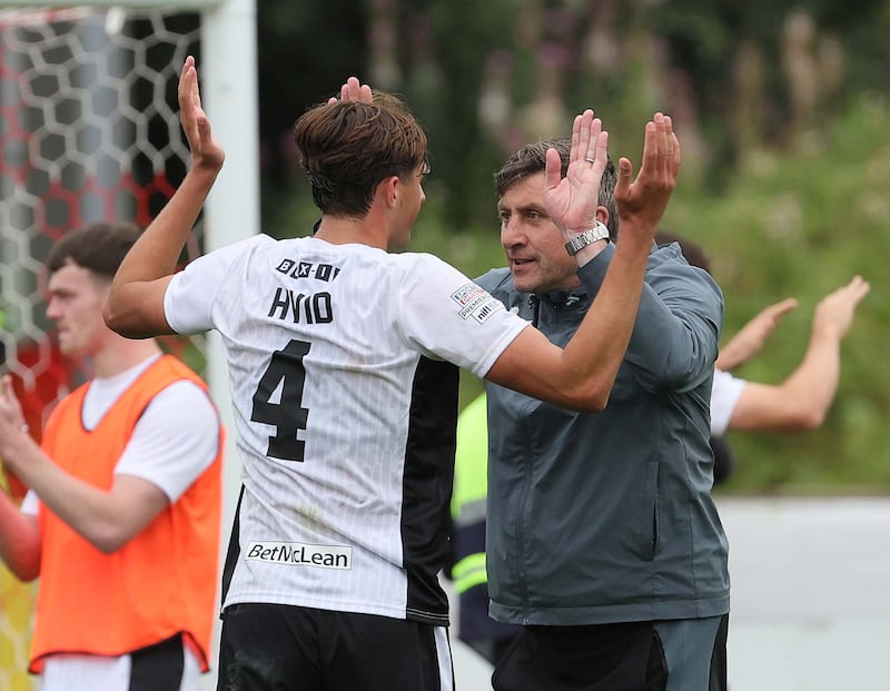 Glentoran manager Declan Devine celebrates with defender Frankie Hvid after today's game at Shamrock Park, Portadown