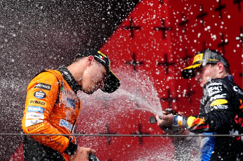 Lando Norris celebrates finishing second to Max Verstappen (right)