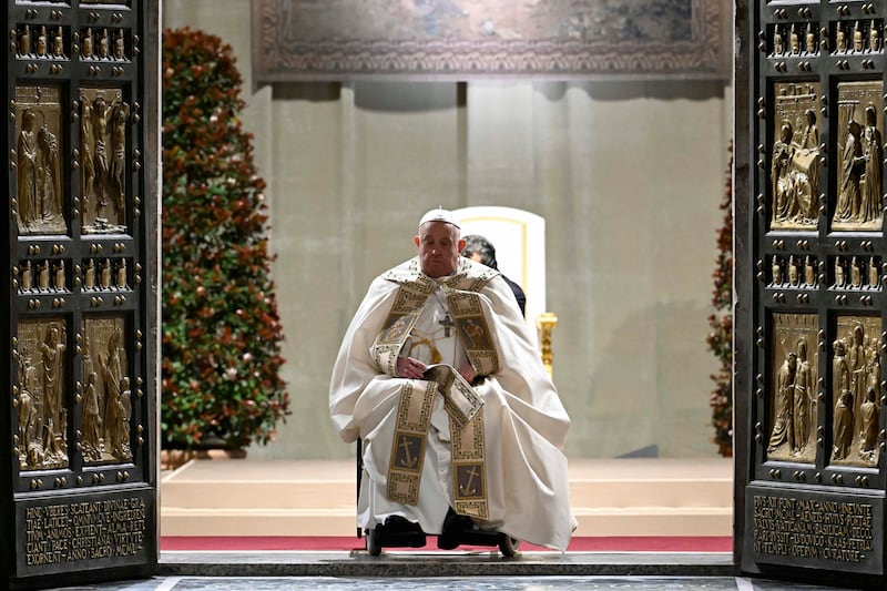 Pope Francis opens the holy door marking the start of the Catholic jubilar year 2025 before presiding over the Christmas Eve Mass in St Peter’s Basilica at the Vatican (Vatican Media, HO/AP)