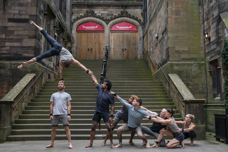 Acrobats from Gravity & Other Myths perform in front of the Assembly Hall in Edinburgh