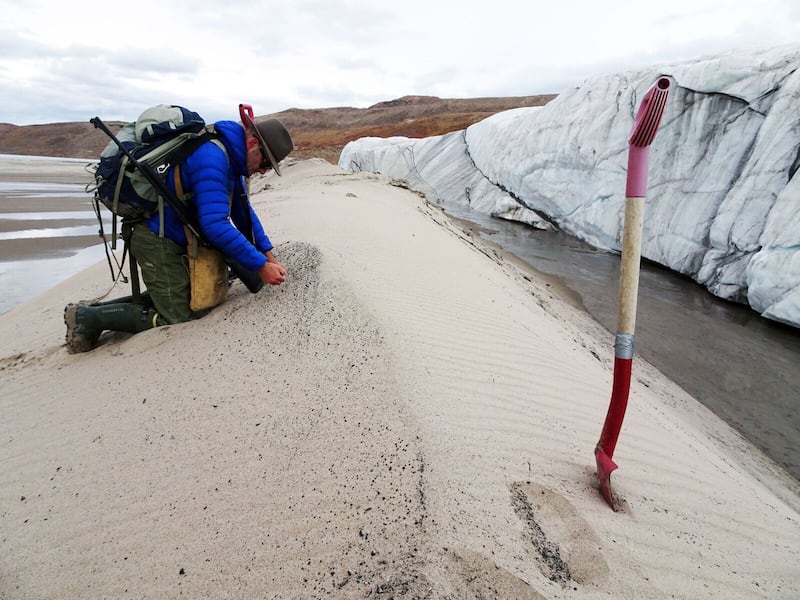 Undated handout photo of Kurt Kjær collecting sand samples at the front of Hiawatha Glacier. Copyright Svend Funder