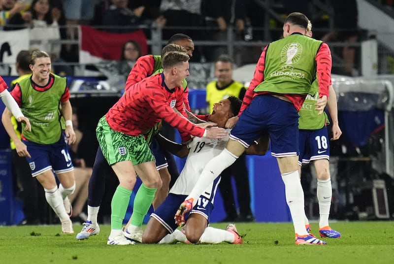 Ollie Watkins (centre) celebrates with the substitutes after scoring the last-gasp winner