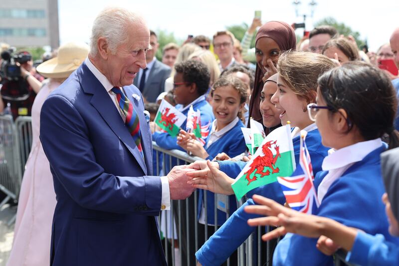 Charles meets schoolchildren after his visit to the Senedd in Cardiff to mark its 25th anniversary on July 11 2024