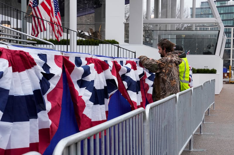 Work continues near the presidential reviewing stand on Pennsylvania Avenue outside the White House (Jon Elswick/AP)