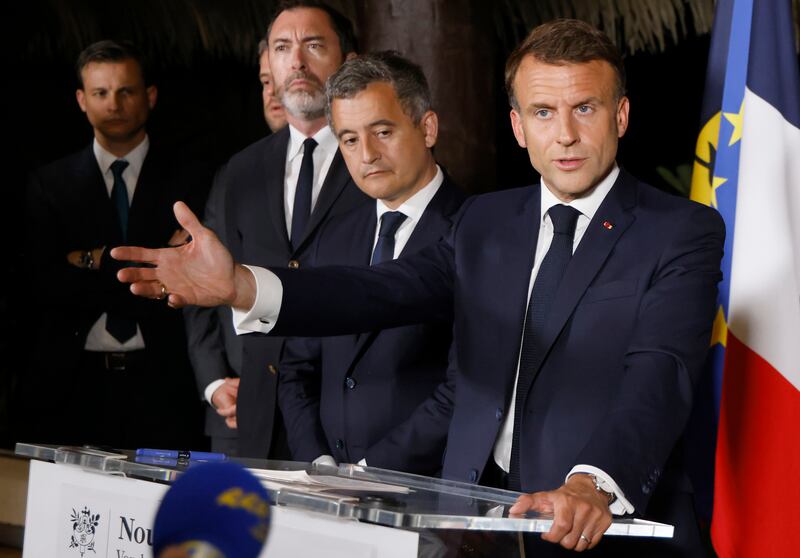 French President Emmanuel Macron delivers a speech at New Caledonia’s High Commissioner residency, with French interior minister Gerald Darmanin, centre, in Noumea on Thursday (Ludovic Marin, Pool via AP)
