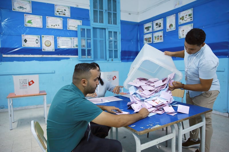 Election officials open a ballot box to count votes in Tunis (Anis Mili/AP)