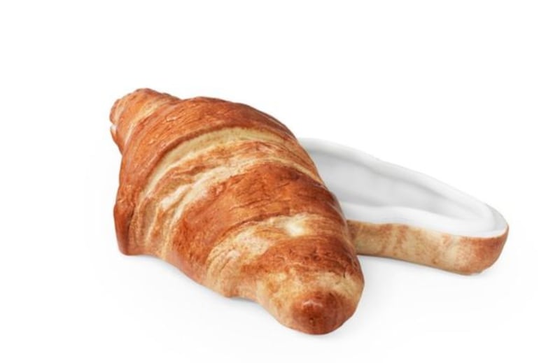 &nbsp;A croissant shaped tin