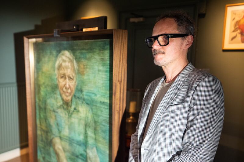 Artist Jonathan Yeo with his portrait of Sir David Attenborough at a private ceremony at the Royal Society in London
