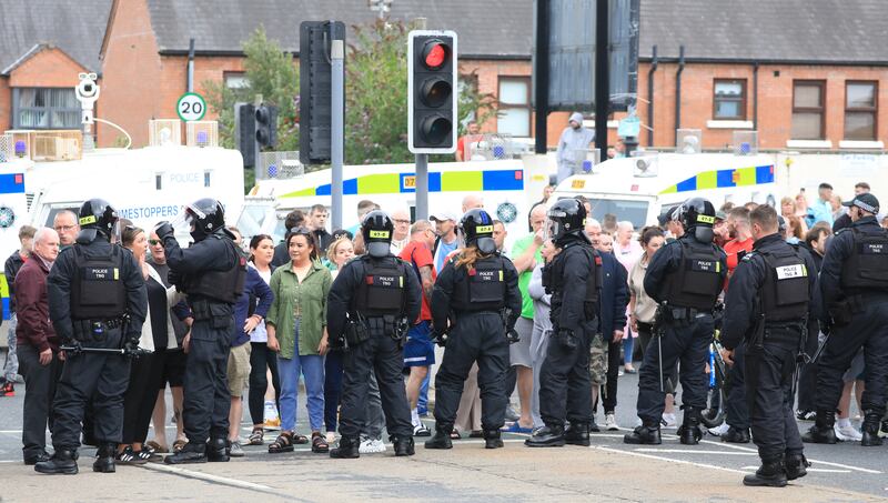 Riot police form a line on the Lower Ormeau Road amid unrest in Belfast