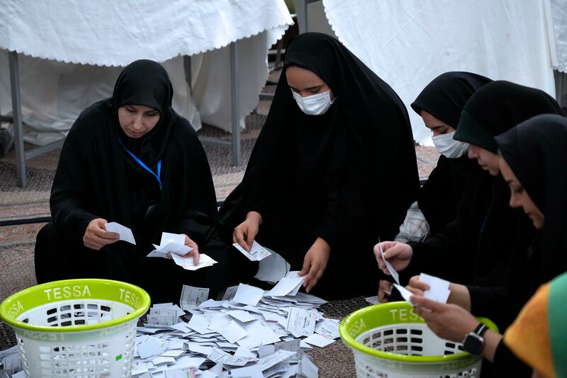 Election officials count ballots for the presidential election at a polling station in Tehran, Iran (Vahid Salemi/AP)