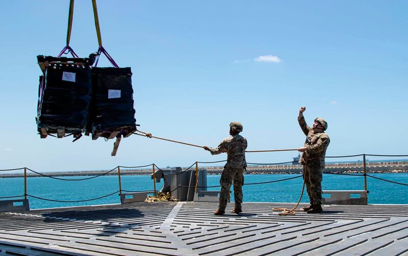 US soldiers stabilise humanitarian aid being lifted by crane aboard the MV Roy P Benavidez in the Port of Ashdod, Israel (Staff Sgt Malcolm Cohens-Ashley/US Army via AP)