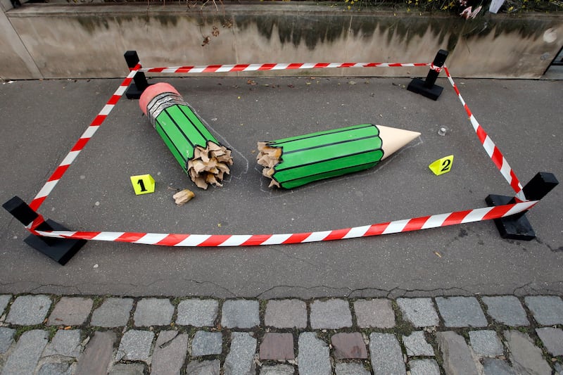 An art installation showing a broken pencil is displayed on the pavement near the Charlie Hebdo office in Paris (Francois Mori/AP)