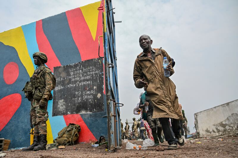 Government soldiers and police officers who surrendered to M23 rebels board trucks to an undisclosed location in Goma earlier in the week (Moses Sawasawa/AP)