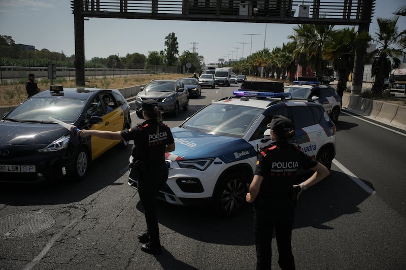 Catalan police man a checkpoint on a road on the outskirts of Barcelona in the search for former Catalan leader Carles Puigdemont (Emilio Morenatti/AP)