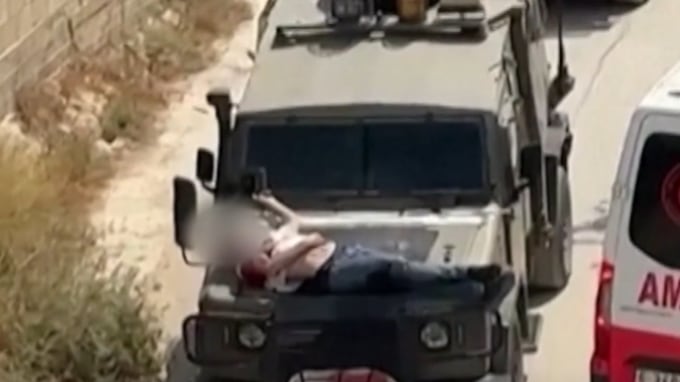 Footage taken on Saturday shows the injured man strapped to an IDF vehicle.
