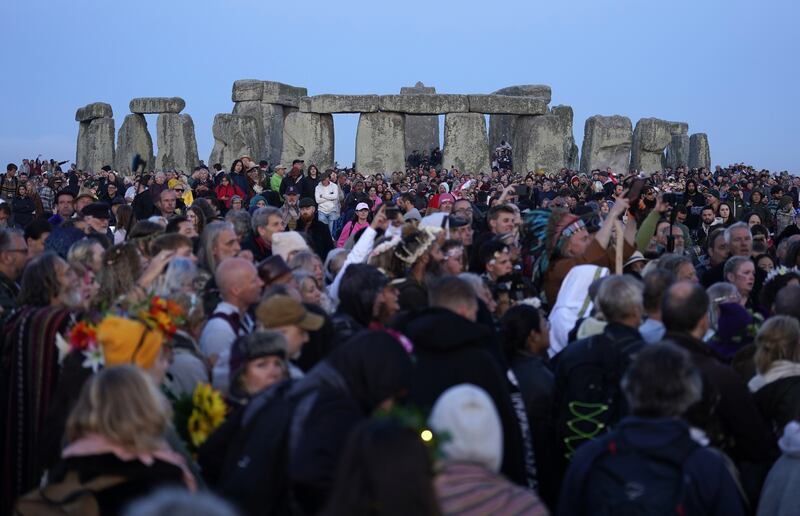 People gather at sunrise to take part in the Summer Solstice at Stonehenge in Wiltshire. (Andrew Matthews/PA Wire)