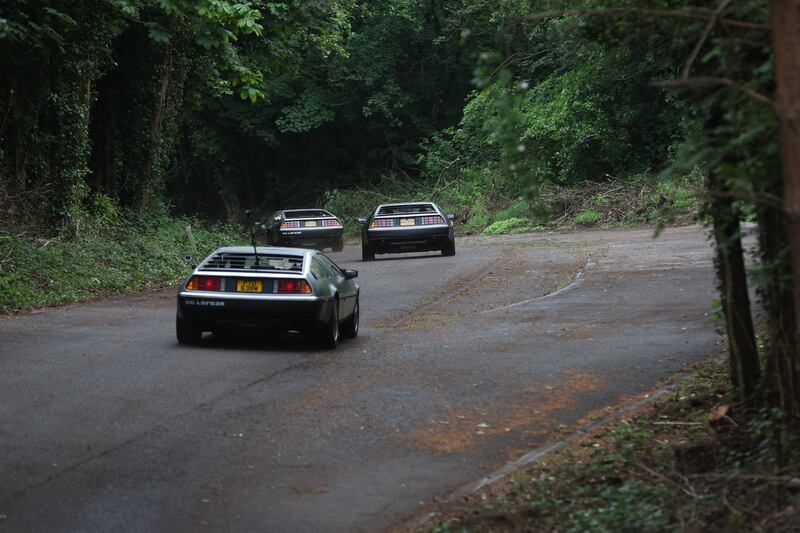 DeLorean owners gather at the Cutts in Dunmurry on Sunday as they drive on the old test track as part of the DeLorean Revival in Belfast.
PICTURE COLM LENAGHAN