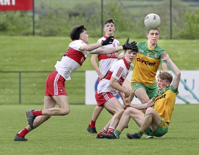 Derry Cahir Spiers with Mark McDevitt of Donegal during the Ulster Minor Football Championship match played at Owenbeg on Saturday 7th May 2022. Picture Margaret McLaughlin. 