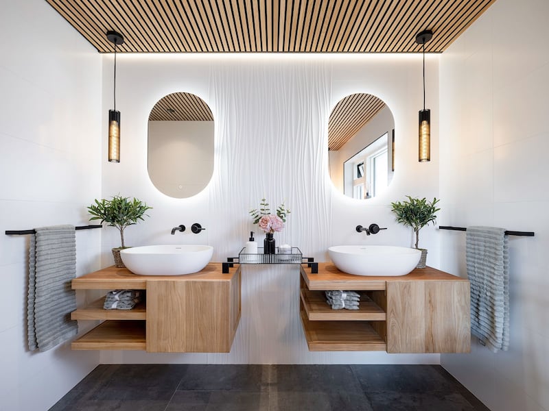 Combining the elements of wood, ceramic tiles and a sophisticated lighting scheme, this recently renovated bathroom exudes spa-like luxury (Cranberryhome/Agata Brennan Photography)