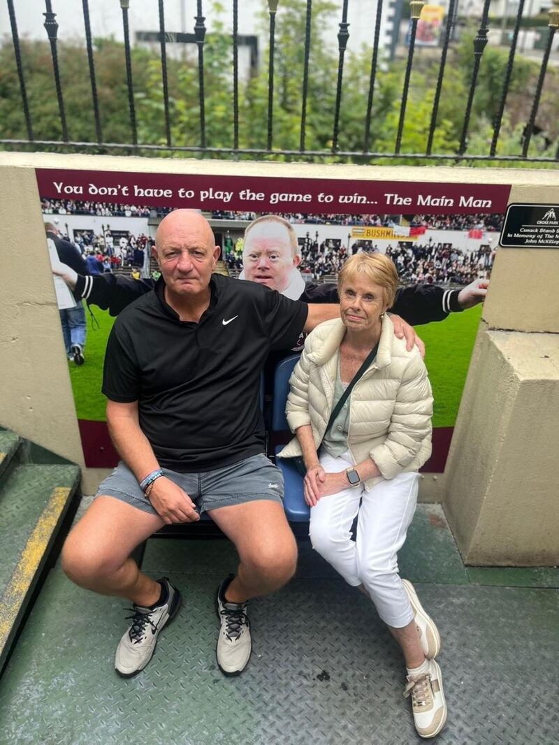 Terence McNaughton with Maureen, sister of the late John McKillop, beside the emblematic image of the 'Main Man' at the Lurig Inn, Cushendall