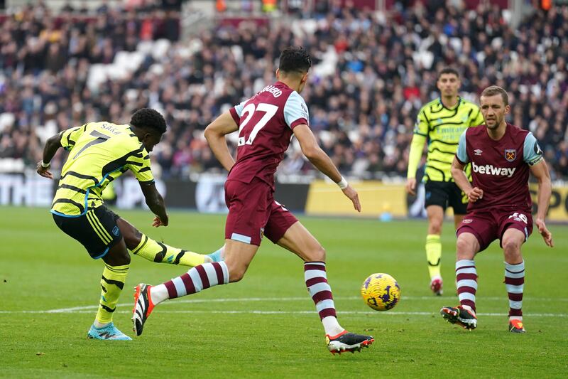 Bukayo Saka, left, scores Arsenal’s fifth goal