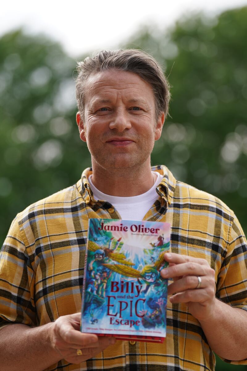 Jamie Oliver holding Billy and the Epic Escape